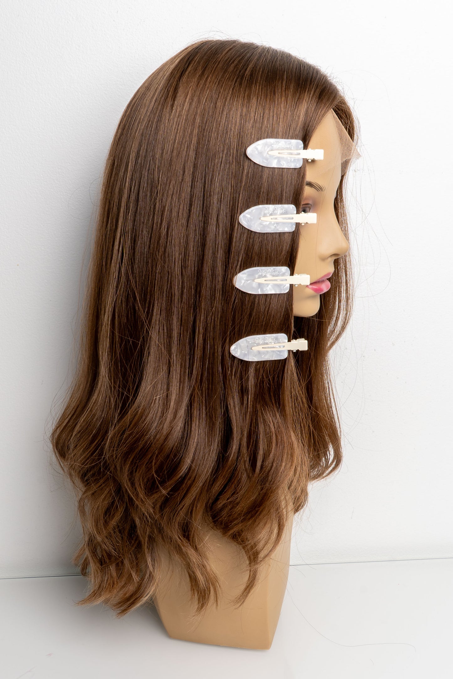 Pearl white creaseless hair clips holding human hair wig in place during styling
